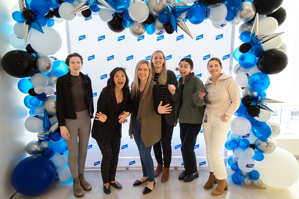 Group of RJF Pro Associates standing as a group under a balloon arch.
