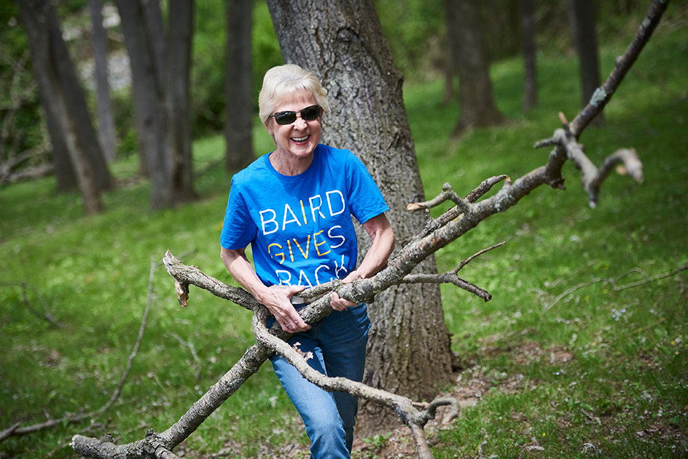 RJF Pro Leadership Team member carrying tree branches while volunteering.
